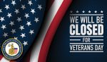 An American Flag waves over a dark background, and the words "We will be closed for Veterans Day"