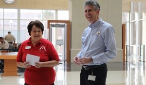 Clerk Gary Cooney presents Linda Krupski, founder of LovExtension, with a monetary donation.
