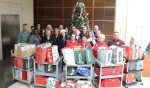 Employees from the Clerk’s Office are joined by Linda Krupski, founder of LovExtension as they present the donated items.