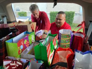 Clerk Gary Cooney (left) and Erik Halili, Senior Clerk with the Records Storage Facility, load the donated gifts for delivery