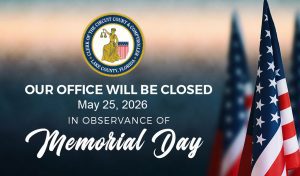 The sun is setting in the background with American flags solemnly placed in the ground and the words, "Our office will be closed May 25, 2026, in observance of Memorial Day."